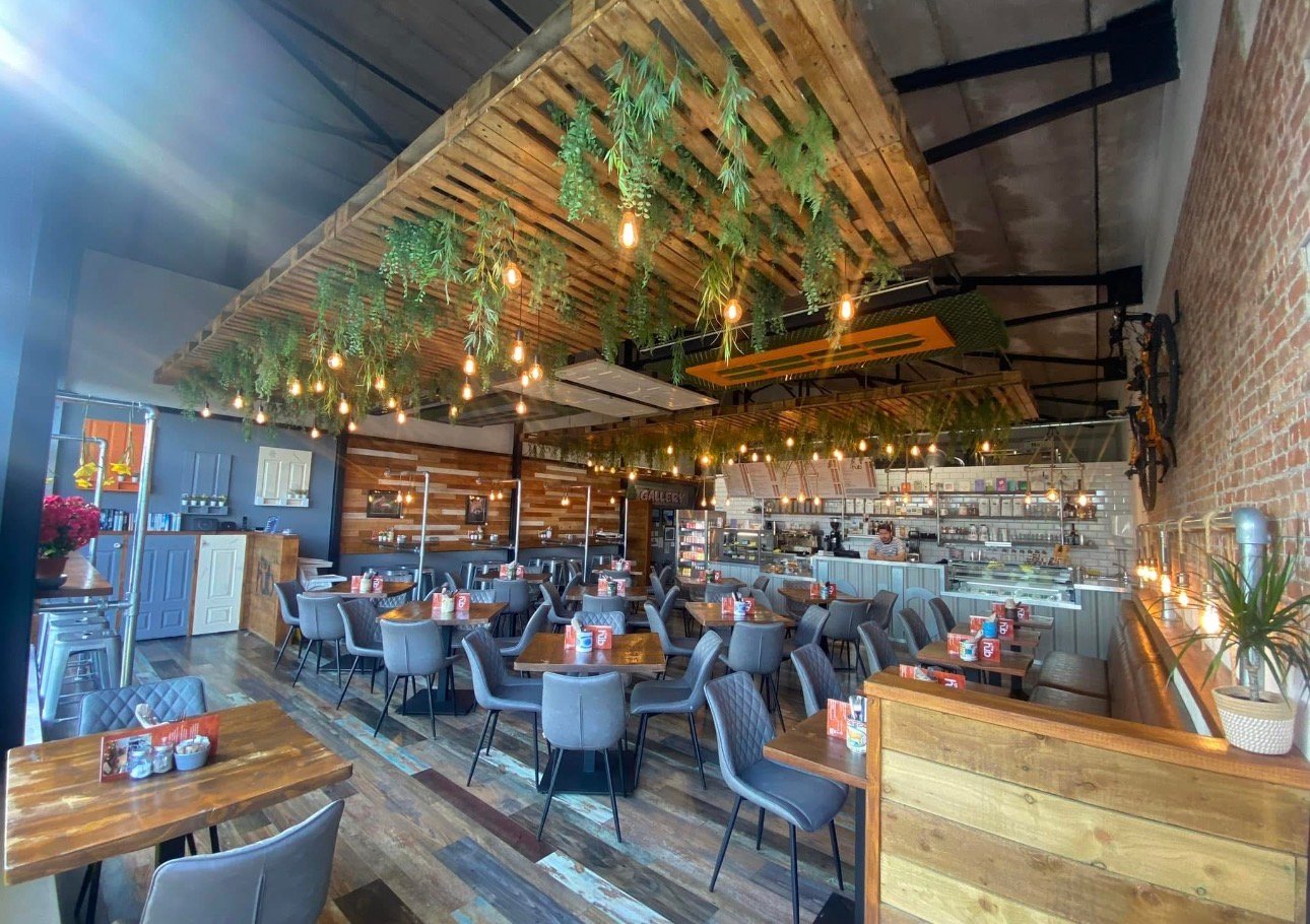 The Hub dining room with warm timber, brickwork and hanging lights